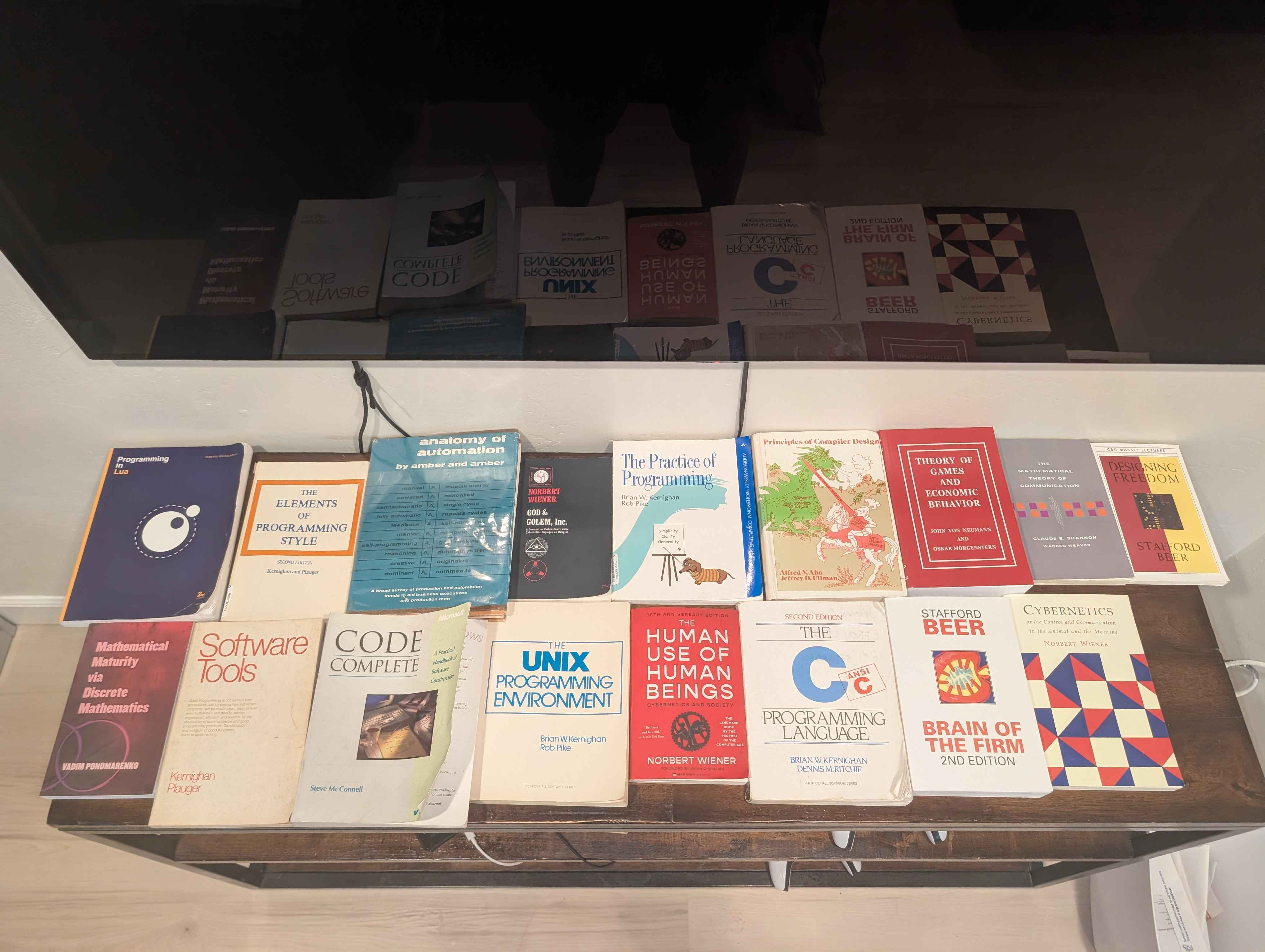 a table covered with the programming books mentioned in the next section